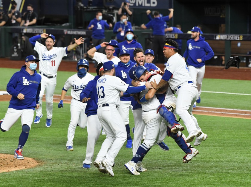 Players on the Los Angeles Dodgers embrace each other after winning Game 6 the 2020 World Series and securing the championship title.