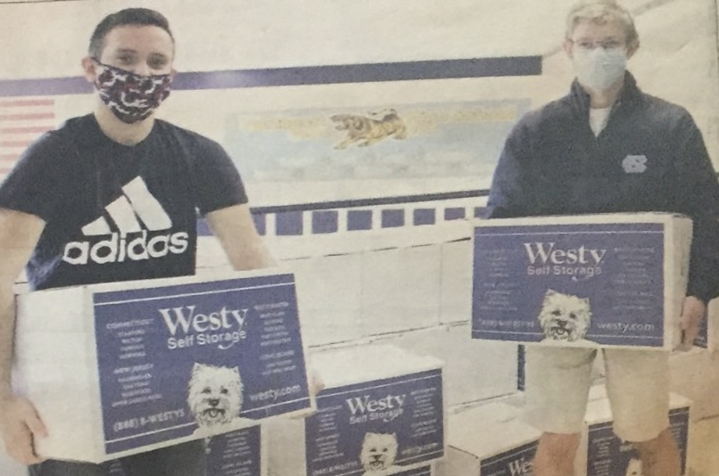 Feed 200 senior leader Ryan Inzerillo and National Honor Society Co-President Griffin Crafa hold Feed 200 boxes. (Credit: The Observer / David Ambro — modified by Griffin Crafa)